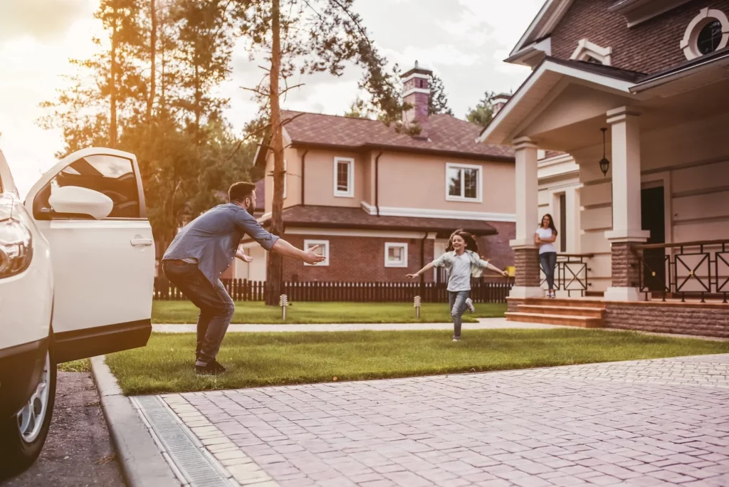 girl running to dad from home with affordable homeowners insurance in Freeland, MI