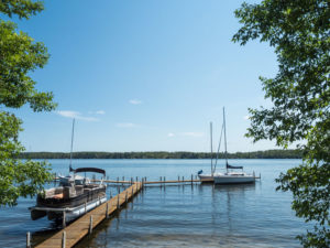 Boats on the lake by the dock with boat insurance in Bay City, MI