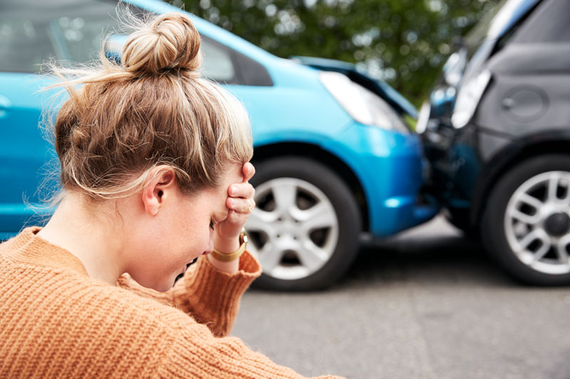 Woman upset by car accident needing Auto Insurance in Bay City, MI